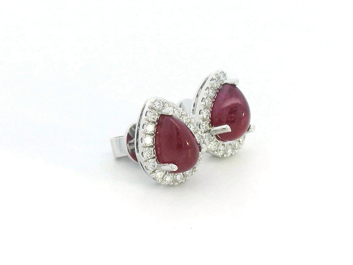 18K gold ruby earrings with pear-shaped 2.21 CT cabochon rubies and diamond halo accents.