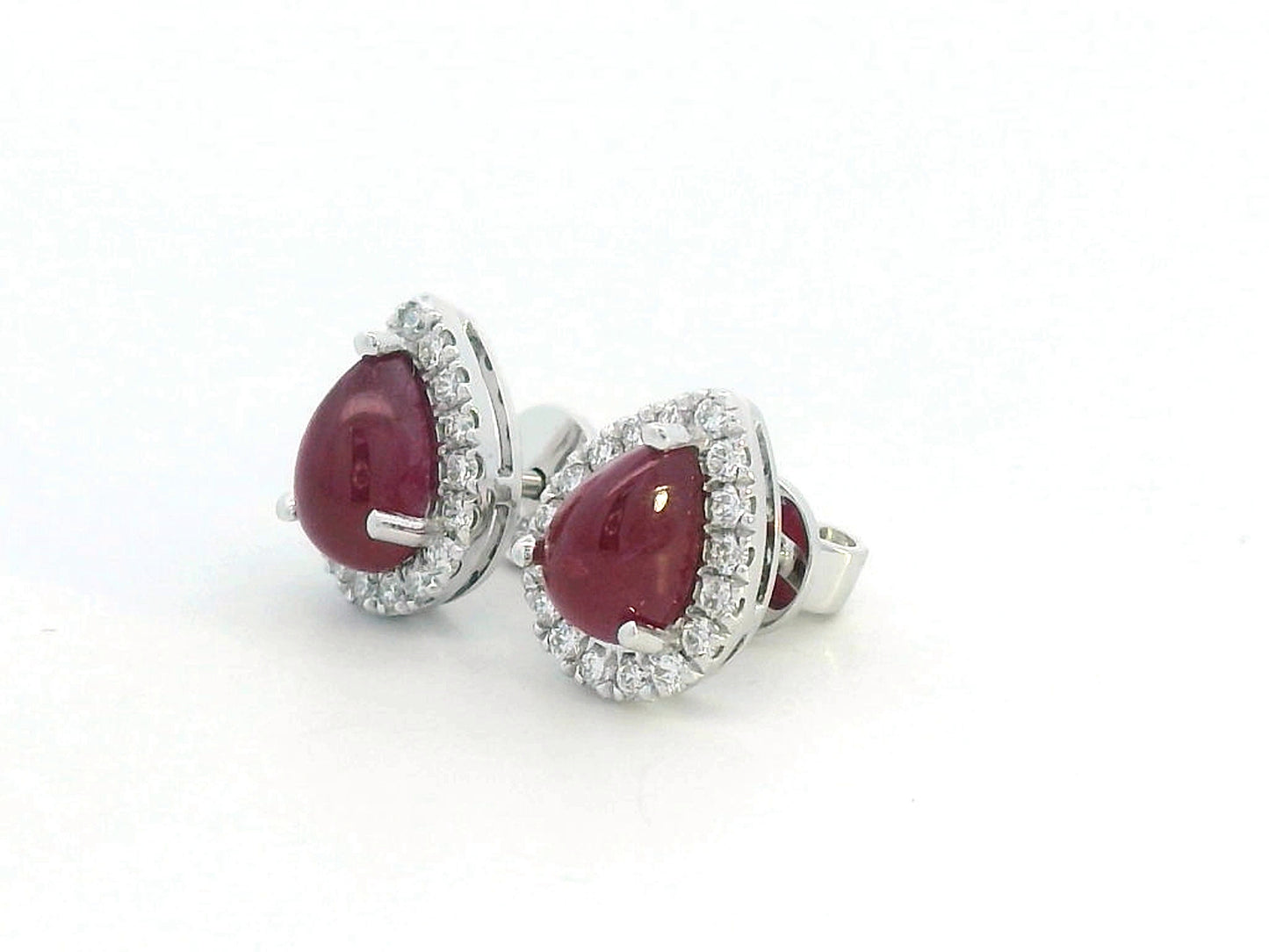18K gold ruby earrings with pear-shaped 2.21 CT cabochon rubies and diamond halo accents.