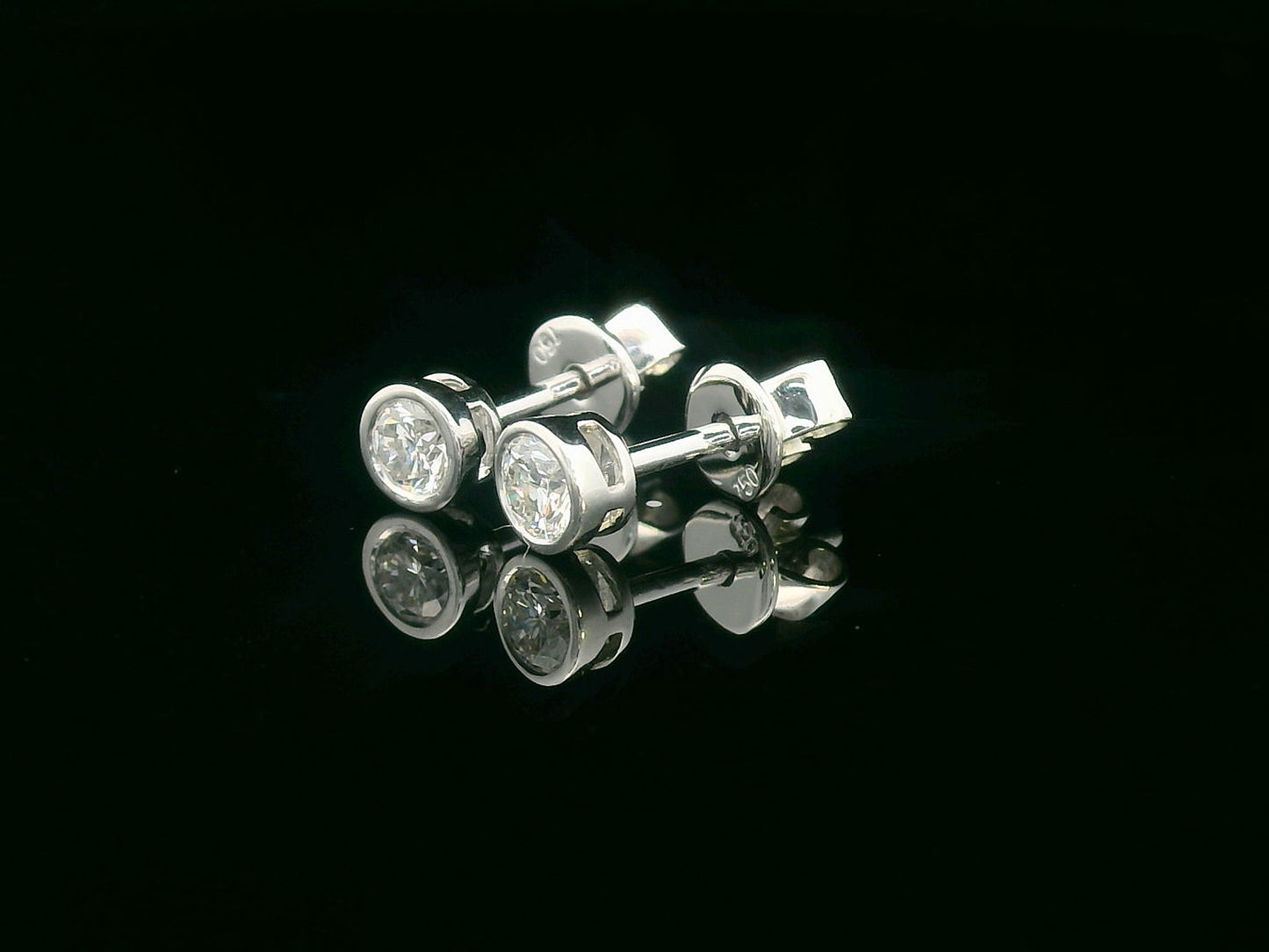 18K white gold bezel set diamond solitaire earrings with 0.32 carat round brilliant diamonds