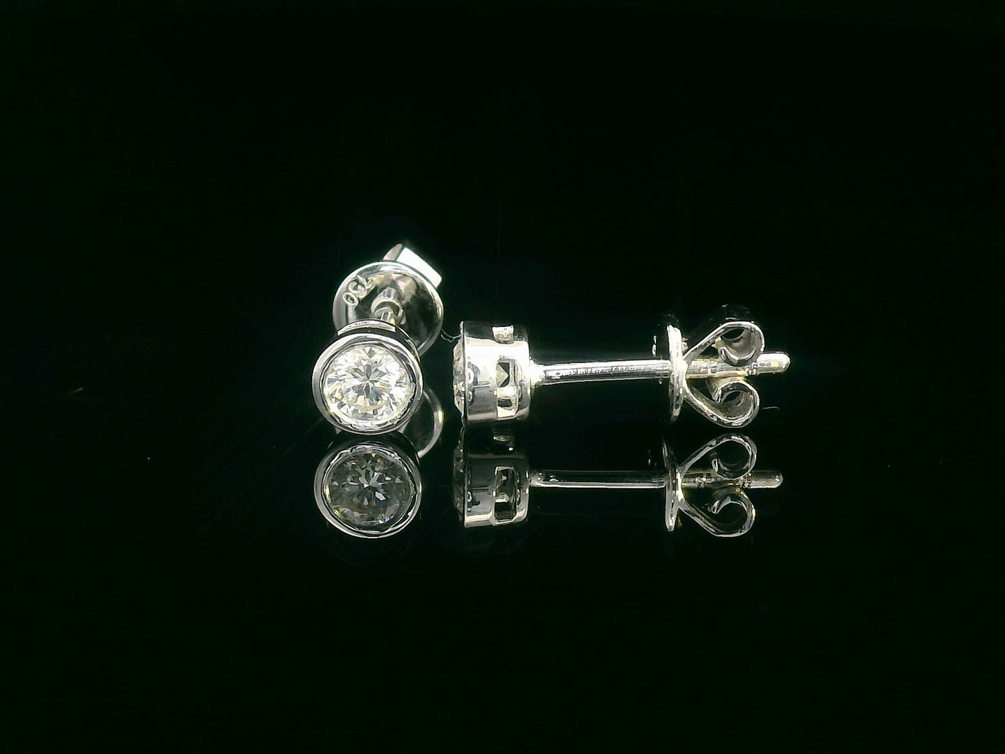 18K white gold bezel set diamond solitaire earrings with 0.32 carat round brilliant diamonds