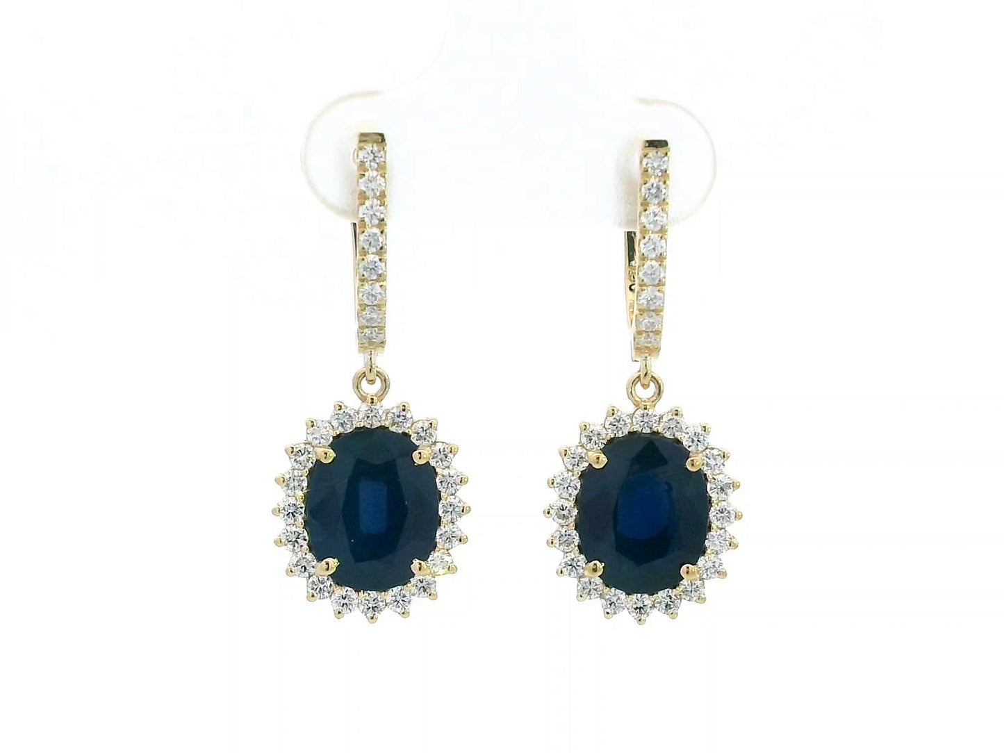 18K yellow gold earrings with 6.41ct oval blue sapphires and 0.91ct diamond sunburst halo design