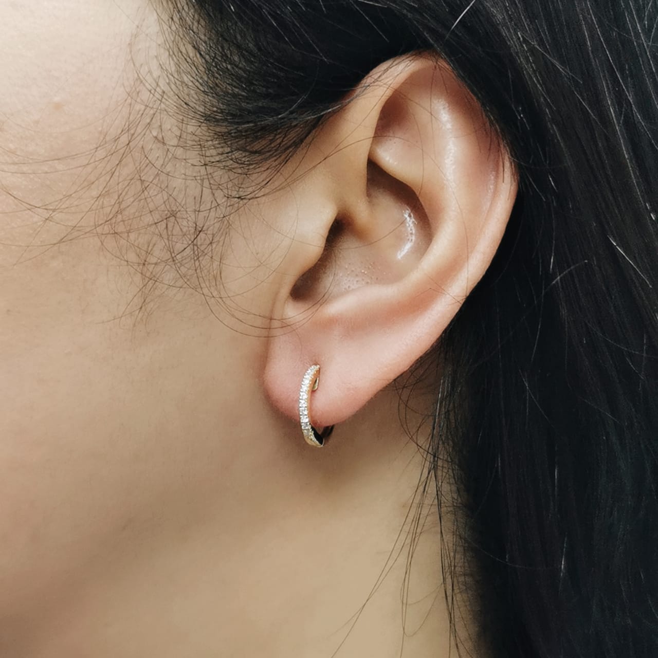Unisex 18K gold huggie hoop earrings with 0.12 carat pavé diamonds, minimalist design
