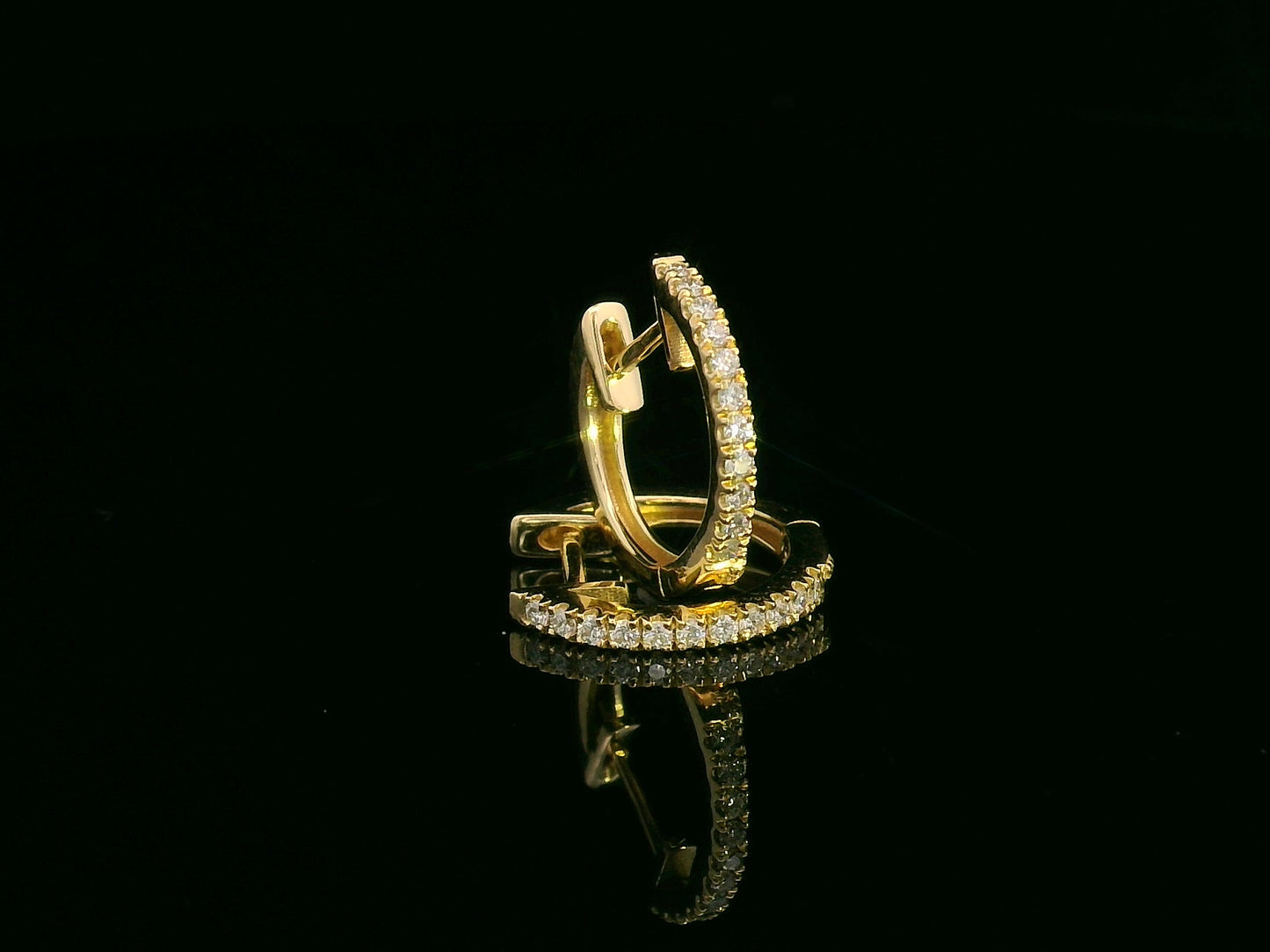 Unisex 18K gold huggie hoop earrings with 0.12 carat pavé diamonds, minimalist design