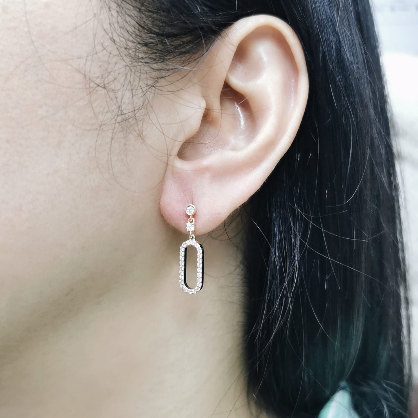 18K yellow gold geometric drop earrings with bezel and pavé diamonds, open oval link design