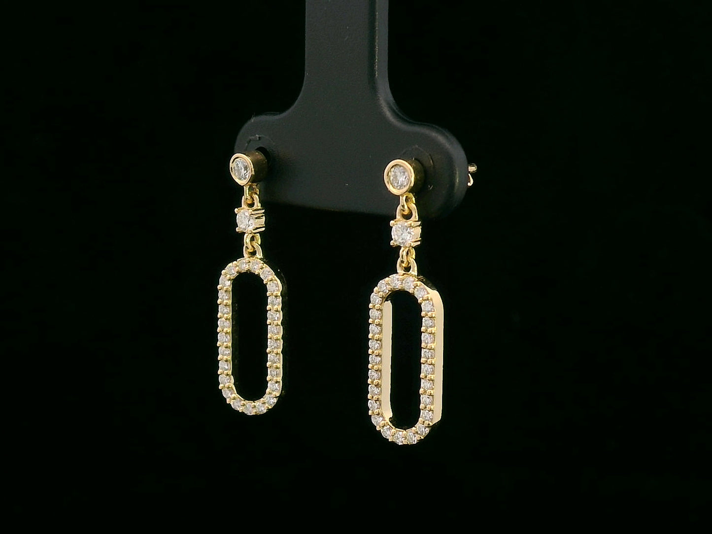 18K yellow gold geometric drop earrings with bezel and pavé diamonds, open oval link design