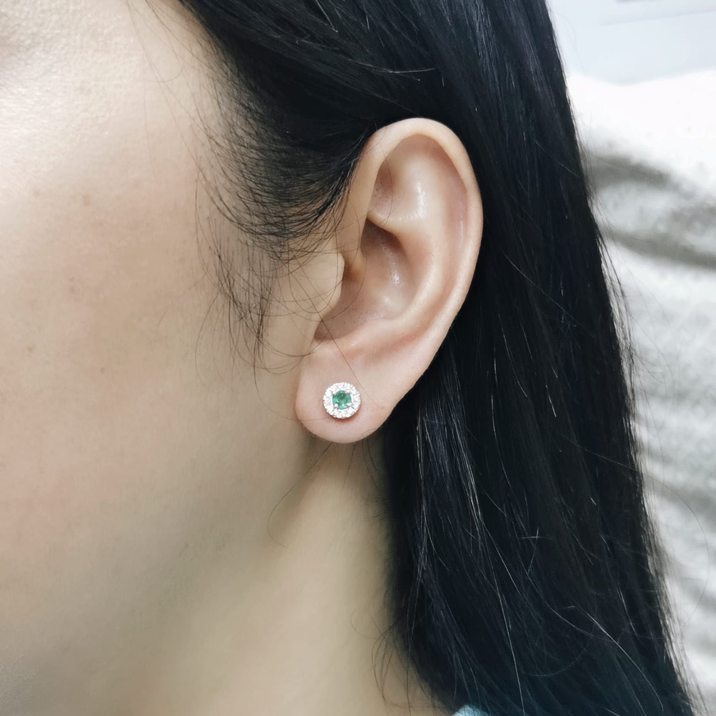 Dainty 18K gold stud earrings with round-cut emeralds and diamond halos