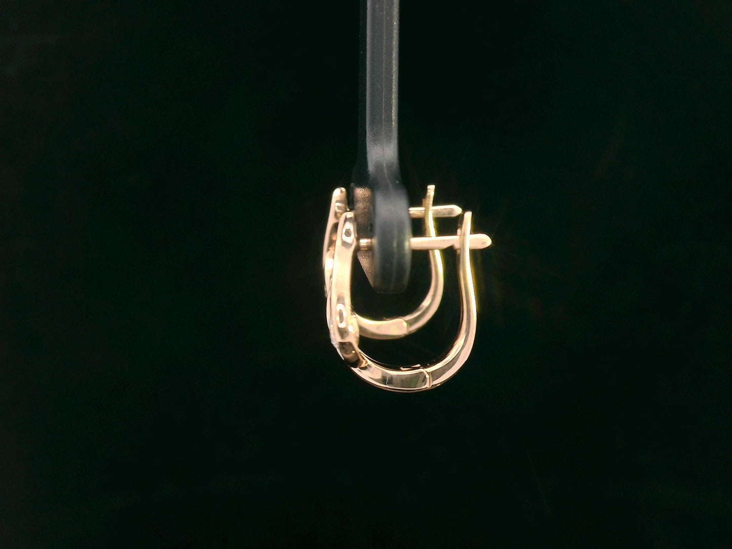18K rose gold earrings with curved twist design and center round diamond