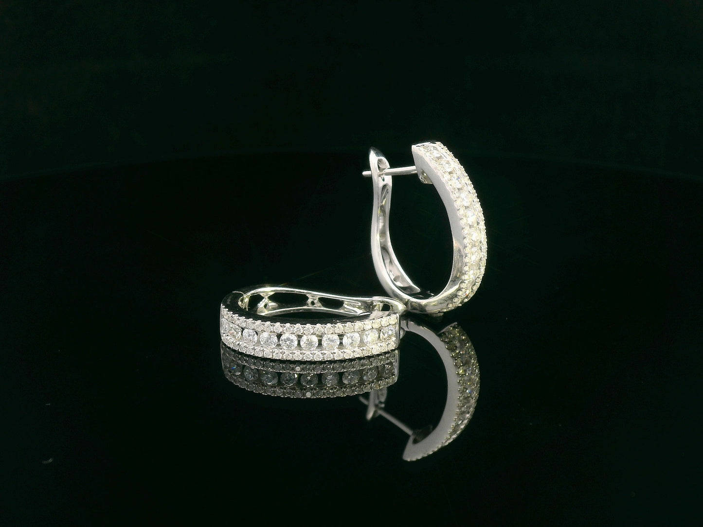 18K white gold hoop earrings with 0.85 carats of round diamonds in a triple-row setting