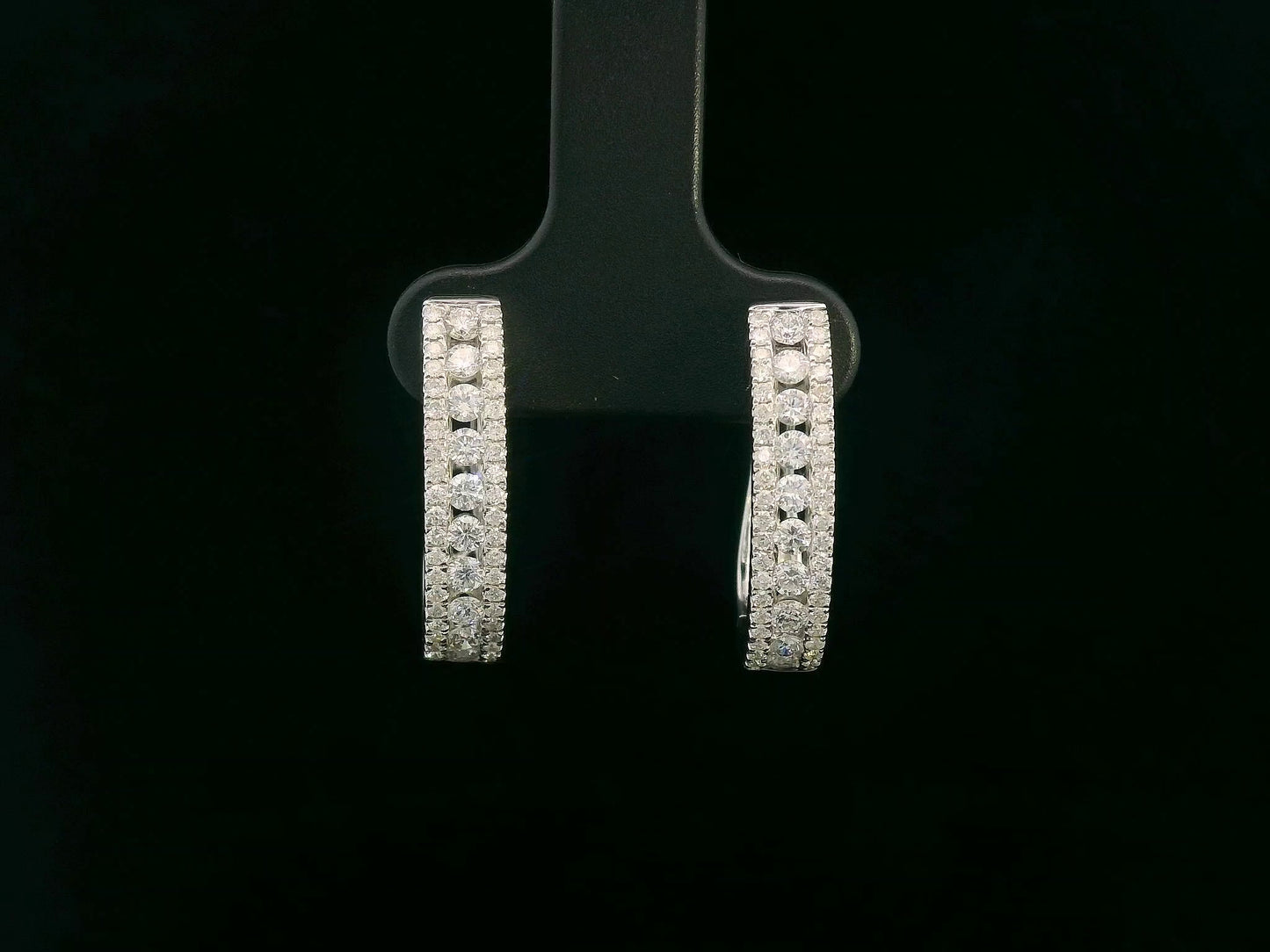 18K white gold hoop earrings with 0.85 carats of round diamonds in a triple-row setting
