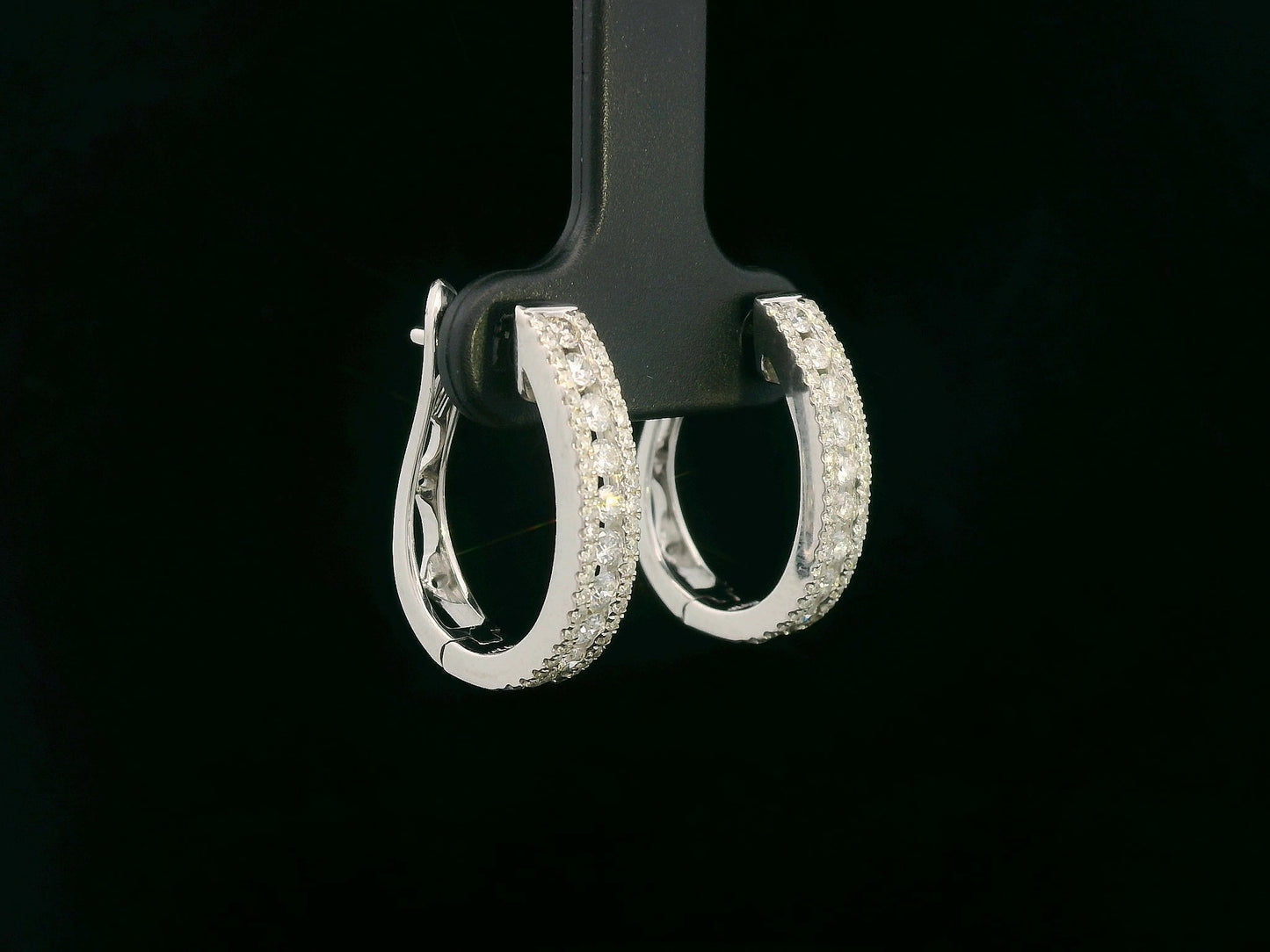 18K white gold hoop earrings with 0.85 carats of round diamonds in a triple-row setting