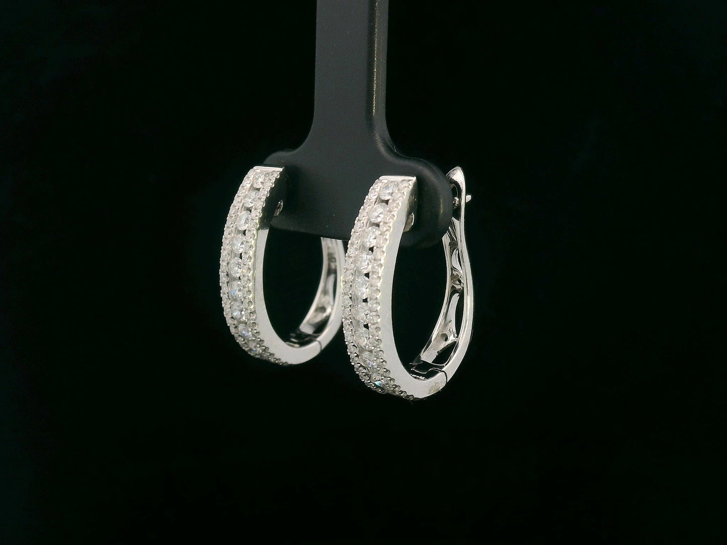 18K white gold hoop earrings with 0.85 carats of round diamonds in a triple-row setting