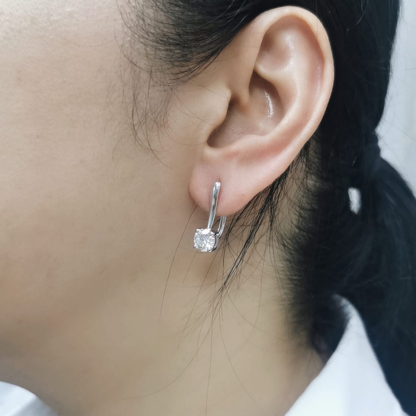 18K white gold diamond drop earrings with 1.01ct and 1.02ct round-cut GIA-certified diamonds in four-prong setting