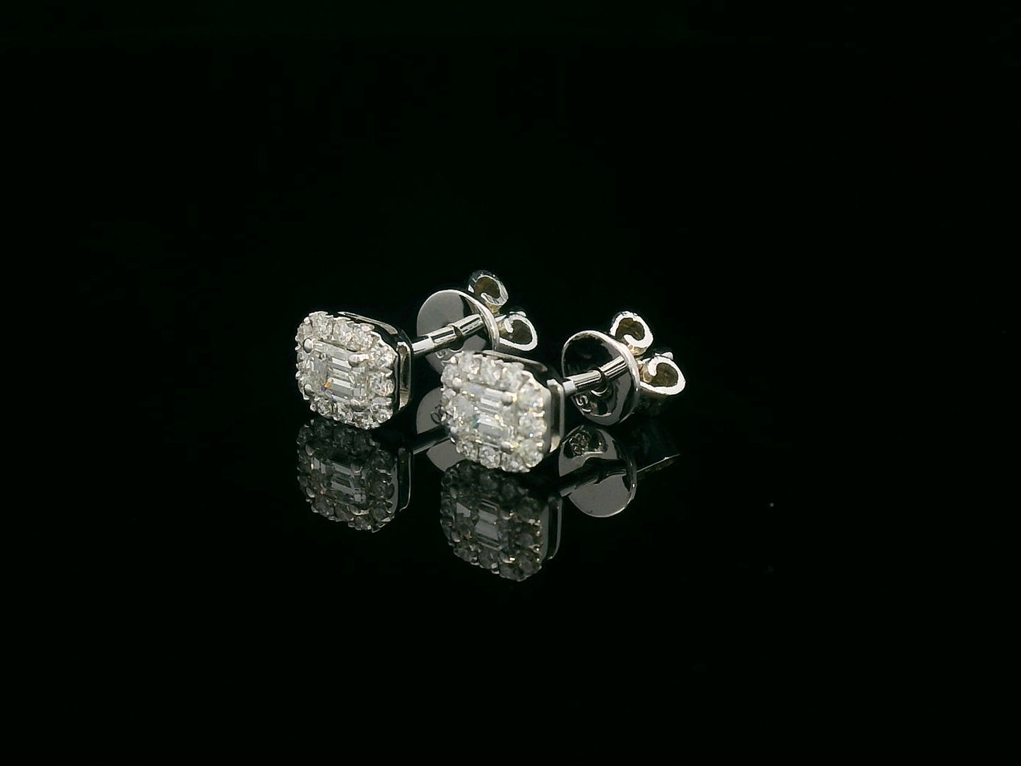 18K gold emerald-cut diamond halo stud earrings with round diamond accents, screw-back style on black background.