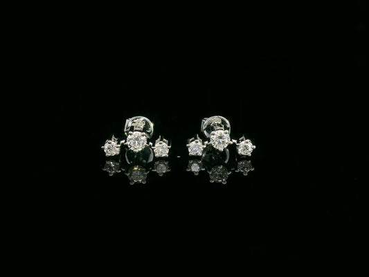 18K gold three-stone diamond stud earrings with graduated round diamonds in a linear design