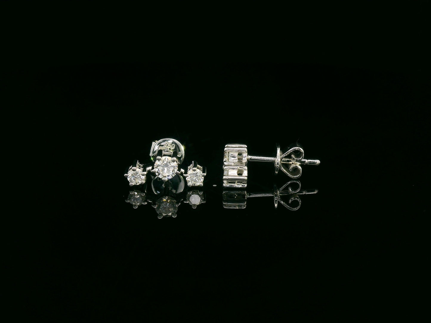 18K gold three-stone diamond stud earrings with graduated round diamonds in a linear design
