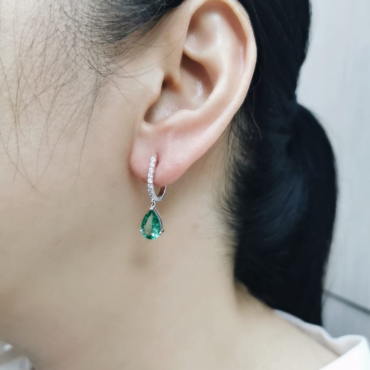 18K white gold drop earrings with pear-shaped emeralds totaling 2.05 carats and 0.22 carats of round diamonds