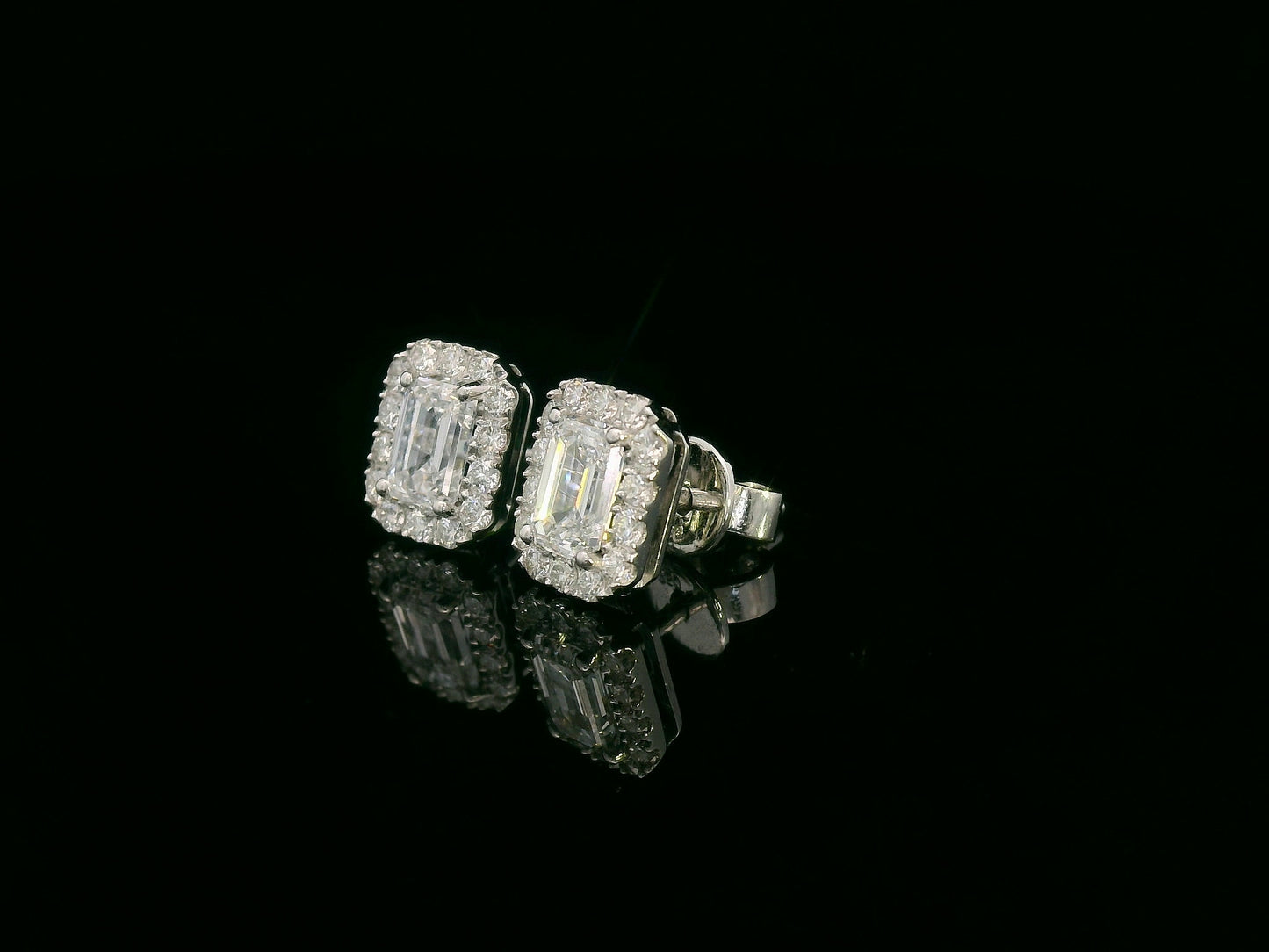 18K white gold emerald-cut diamond halo stud earrings with 1.04ct GIA diamonds and 0.35ct halo accents