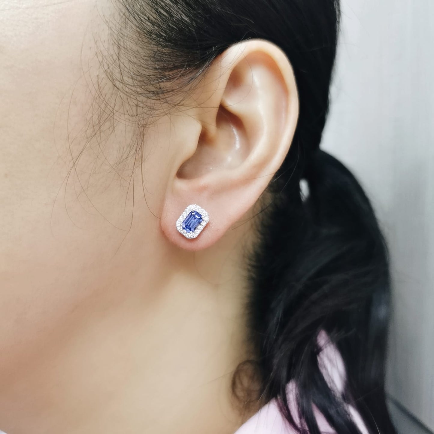Emerald-cut Tanzanite and diamond halo stud earrings in 18K white gold