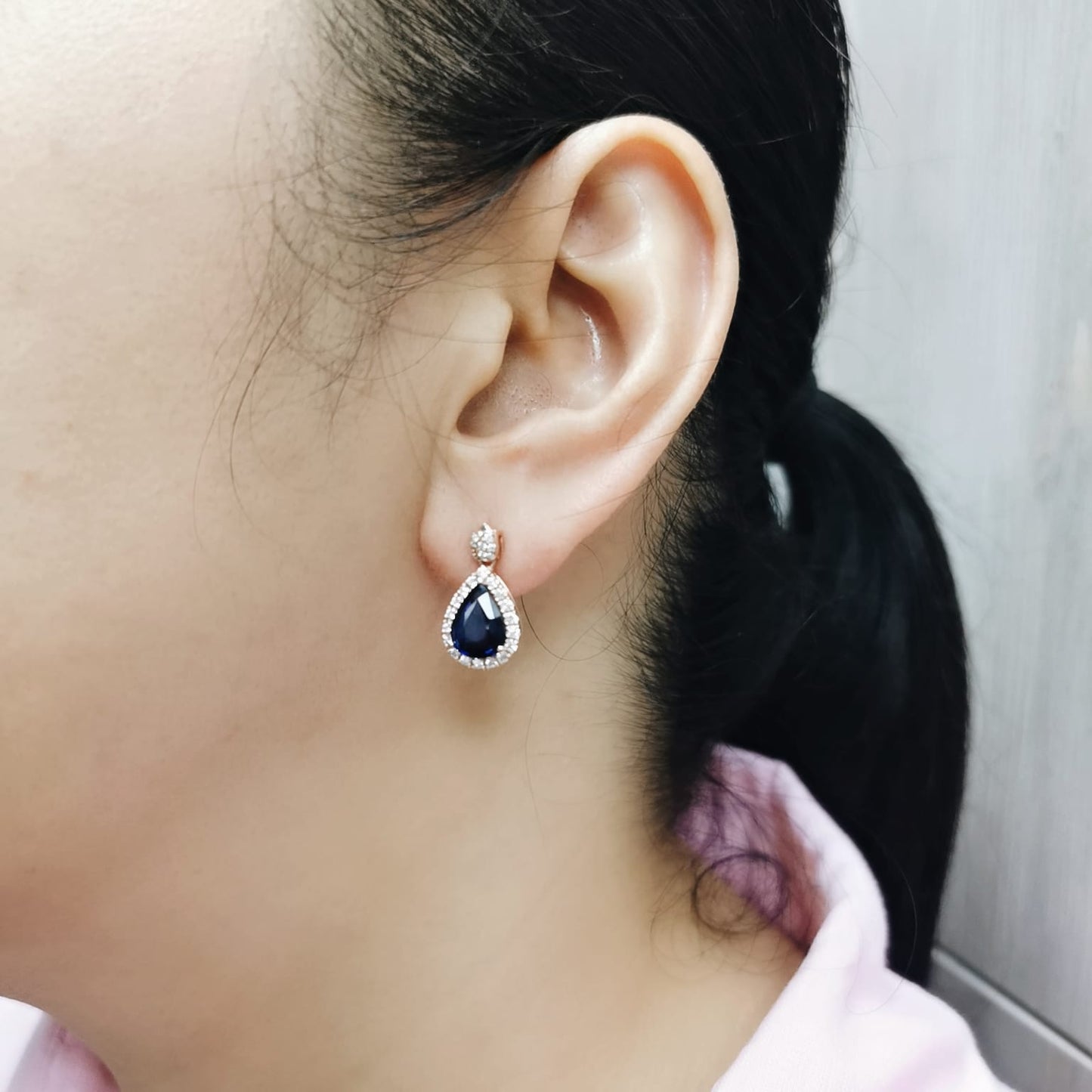 18K rose gold pear-shaped blue sapphire drop earrings with diamond halo and tulip motif