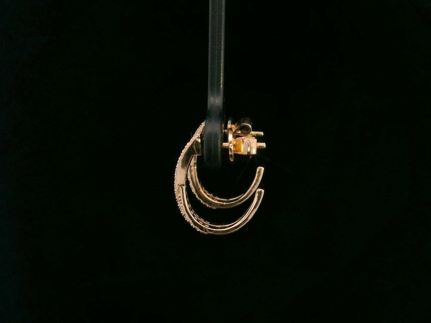 Crisscross diamond half-hoop earrings in 18K rose gold featuring 0.28 carats of pavé-set round diamonds in an overlapping X design.
