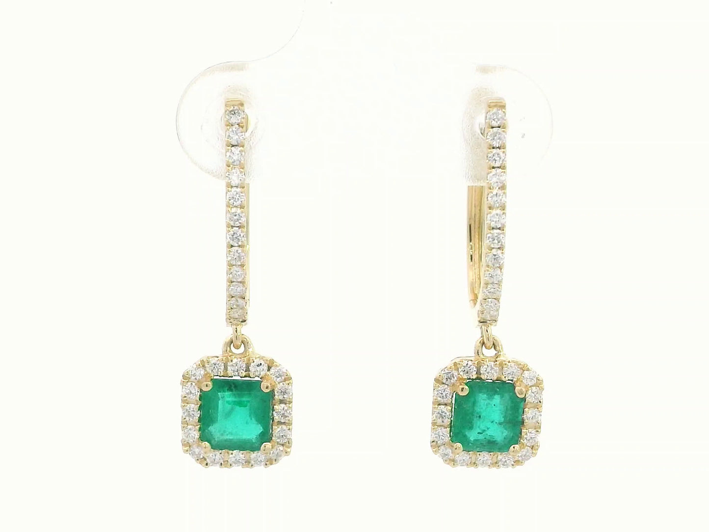 Emerald-cut emerald drop earrings in yellow gold with diamond halo