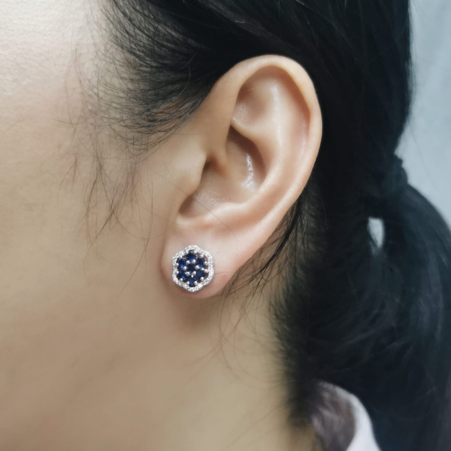 Blue sapphire cluster earrings with diamond halo