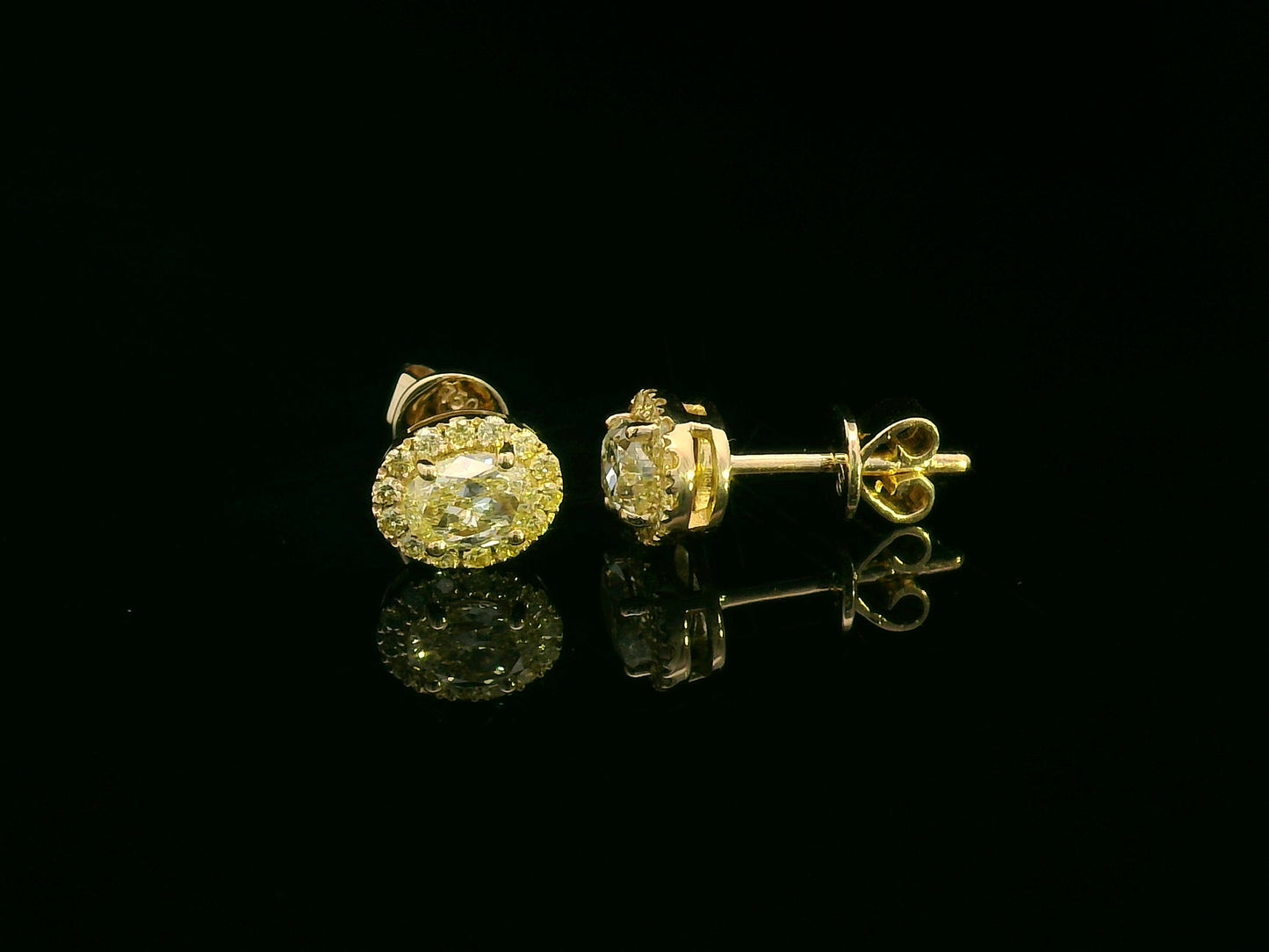 Classic halo diamond earrings in yellow gold featuring vibrant yellow center stones