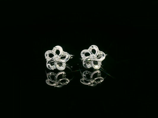 18K white gold floral earrings with diamond petals and center