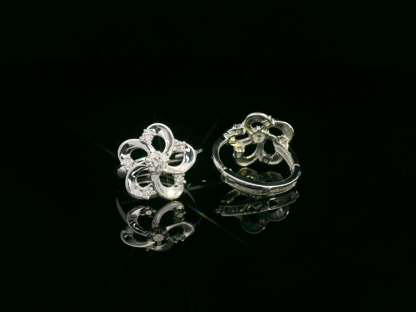 White gold earrings shaped like a flower with diamond accents