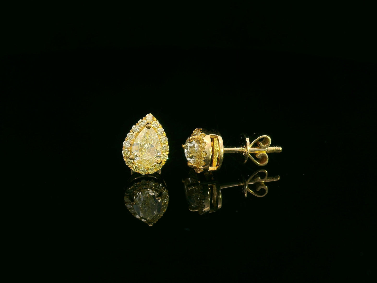 Pear-shaped fancy yellow diamond halo earrings in yellow gold setting
