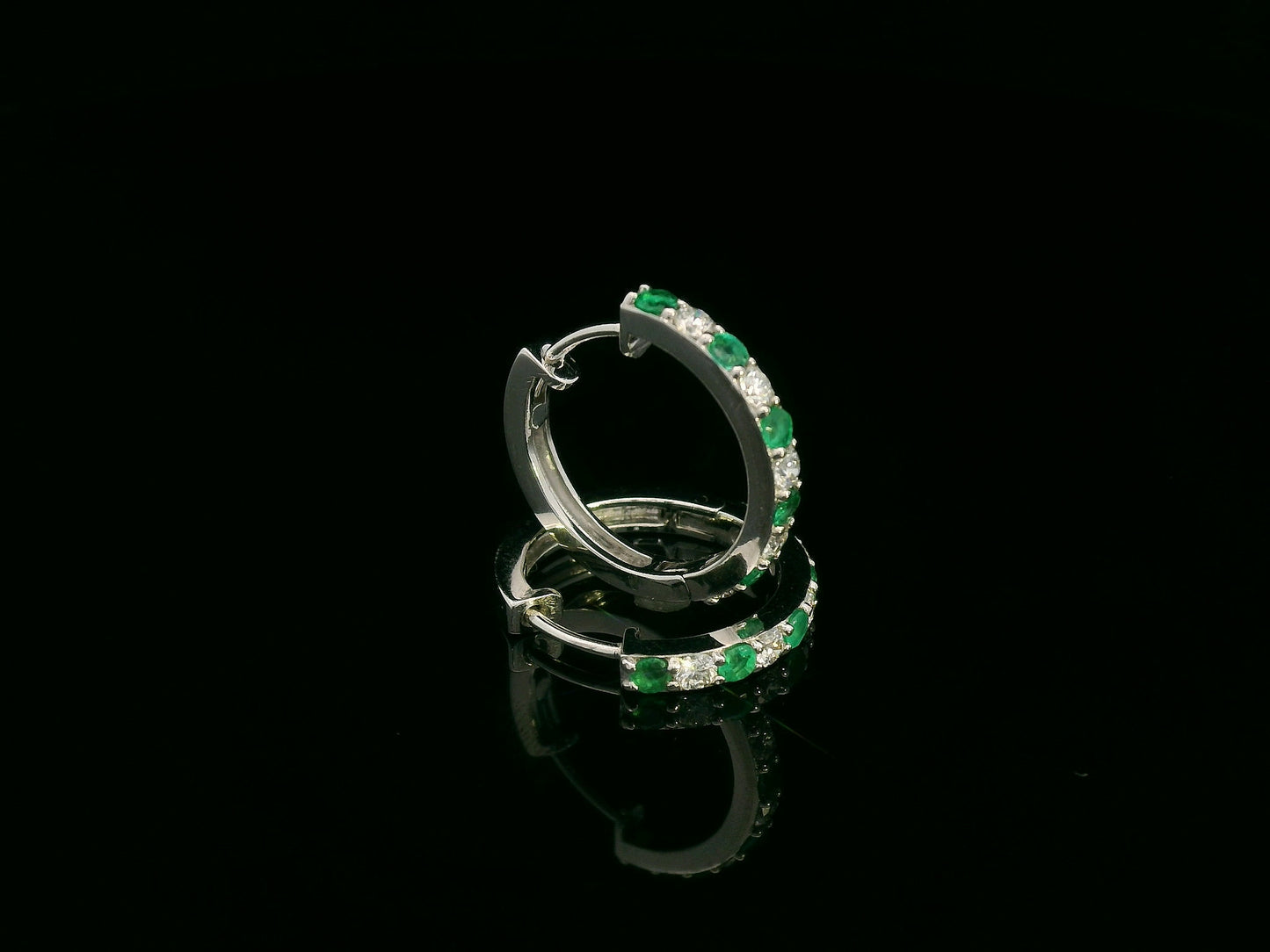 Elegant diamond and emerald gemstone hoop earrings in luxury gift box