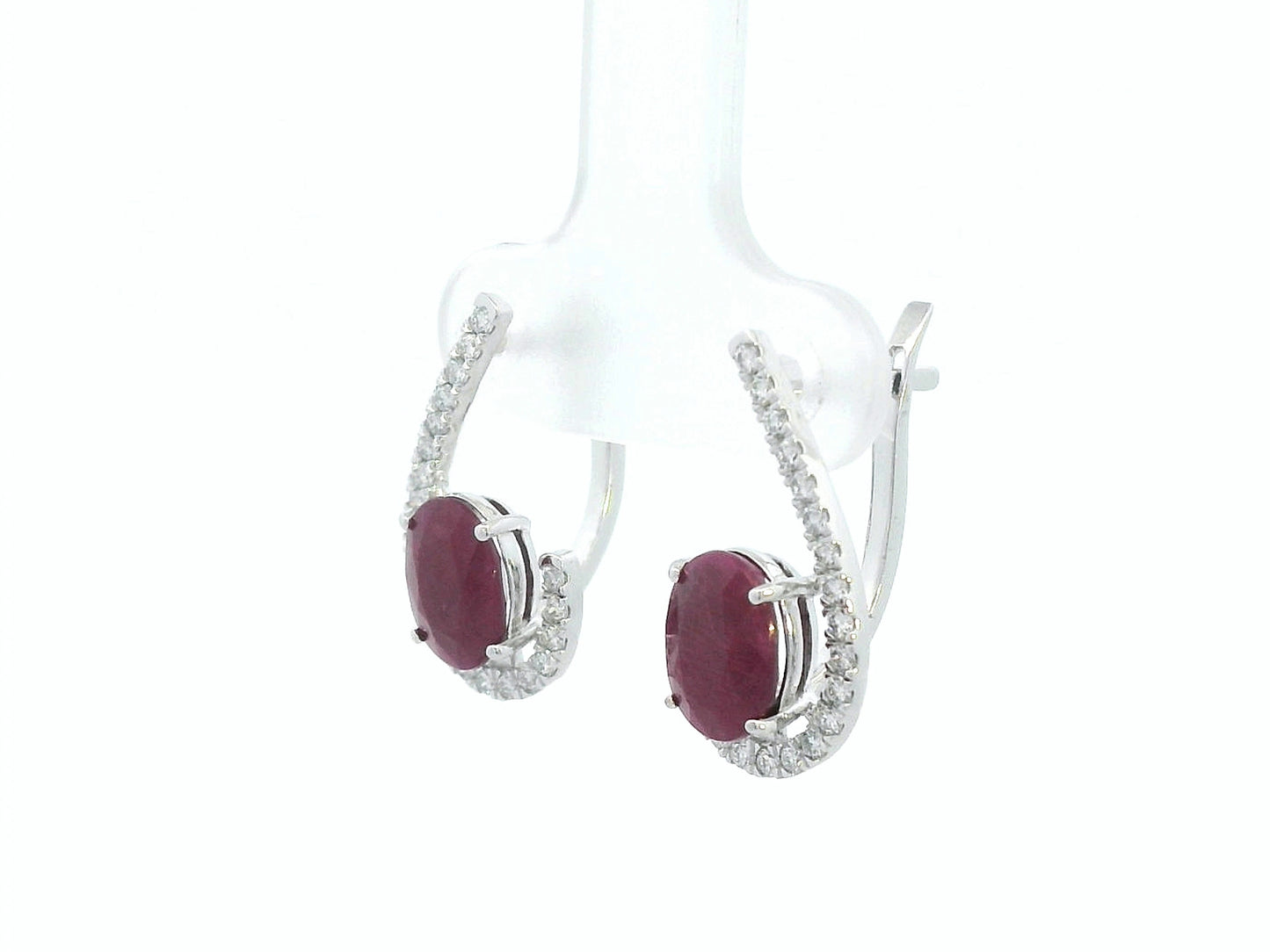 Side profile of 18k white gold ruby and diamond pave curve earrings, showing depth and curved design
