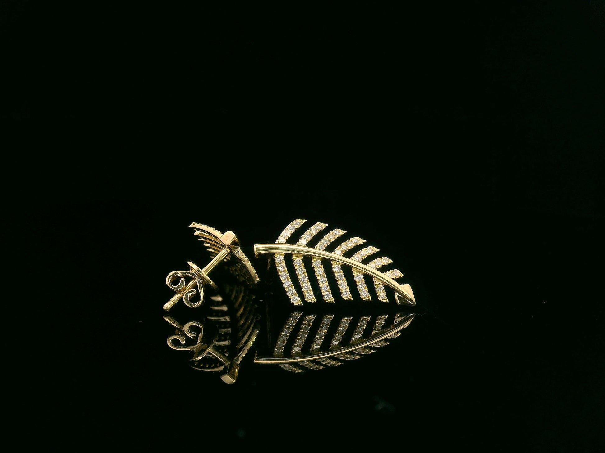 18K yellow gold leaf-shaped stud earrings with pavé diamonds, nature-inspired elegant design