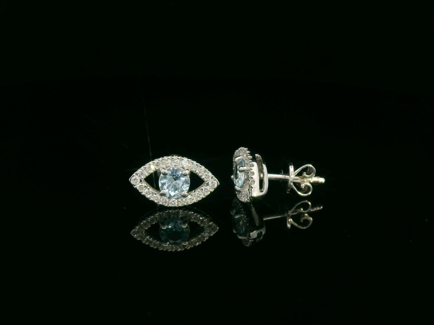 18K white gold evil-eye stud earrings with 0.40ct aquamarine center and 0.23ct pavé diamond halo