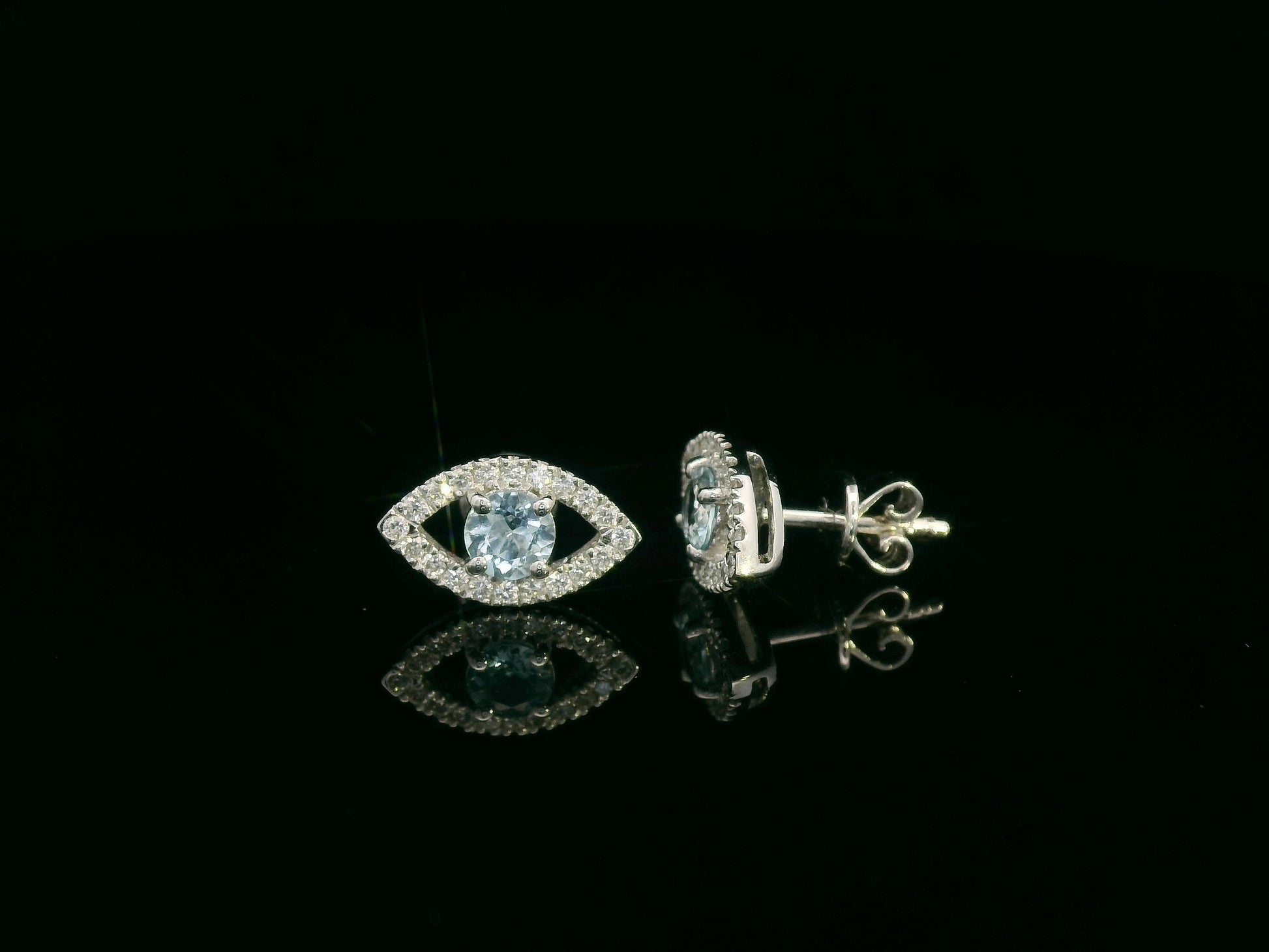 18K white gold evil-eye stud earrings with 0.40ct aquamarine center and 0.23ct pavé diamond halo