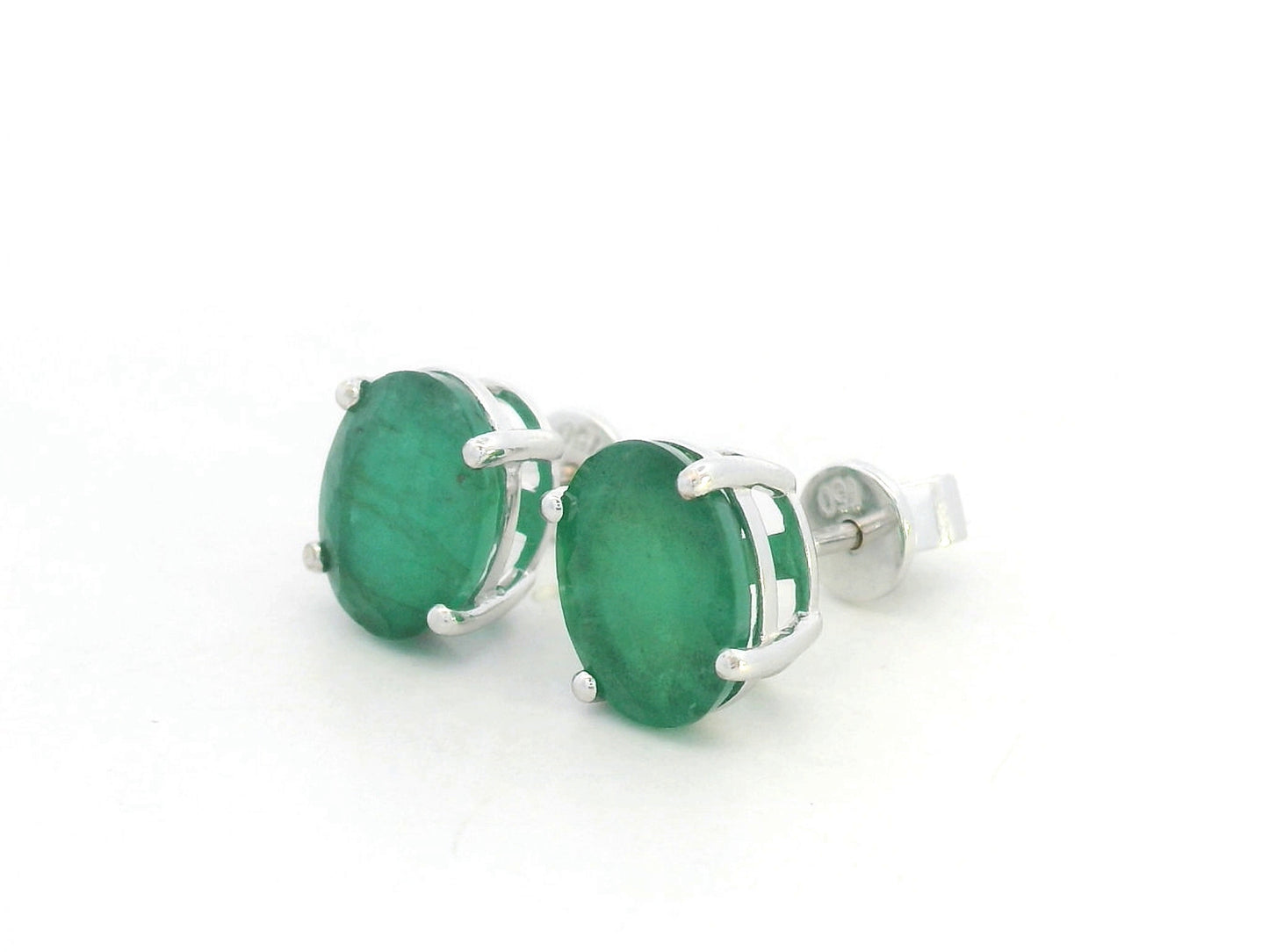 Oval-cut emerald stud earrings in 18K white gold with 3.87 carat total emerald weight by Emirates Diamonds