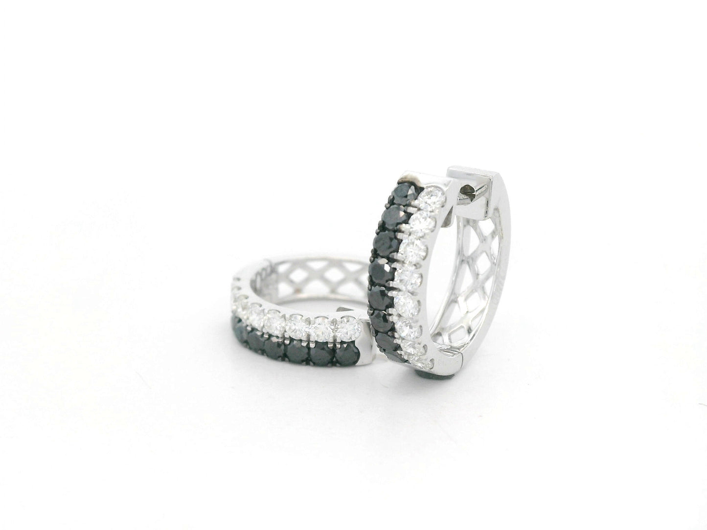 18K white gold hoop earrings with white and black pavé-set diamonds, modern luxury design by Emirates Diamonds.