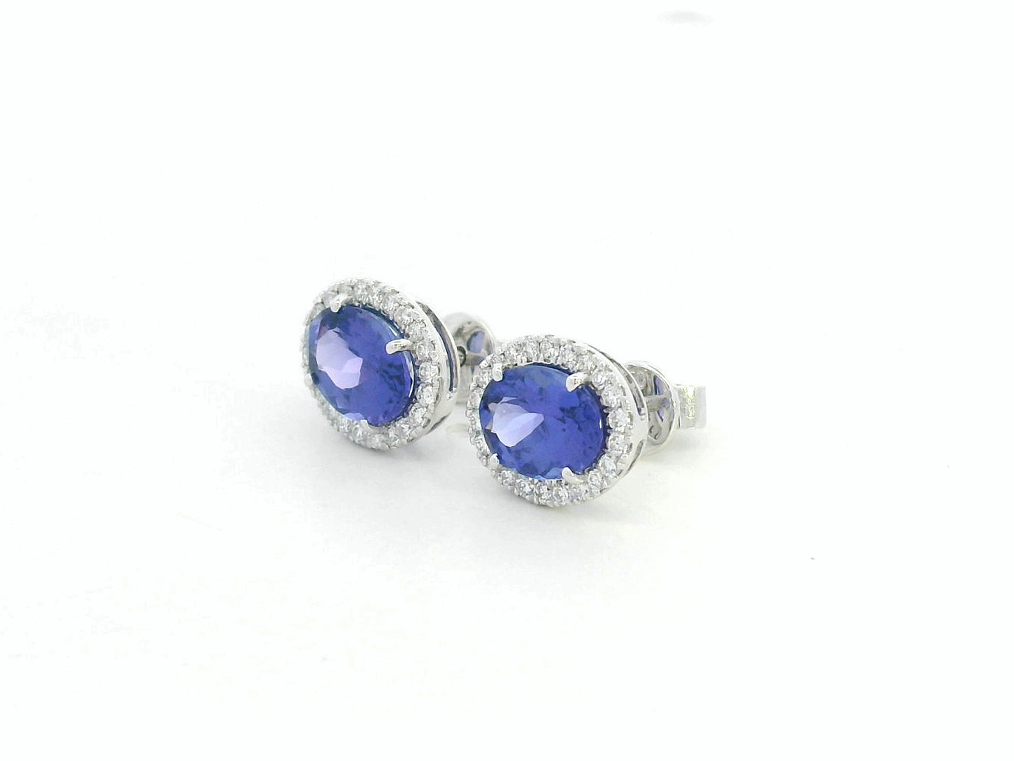 Tanzanite and diamond halo stud earrings in 18K white gold by Emirates Diamonds.