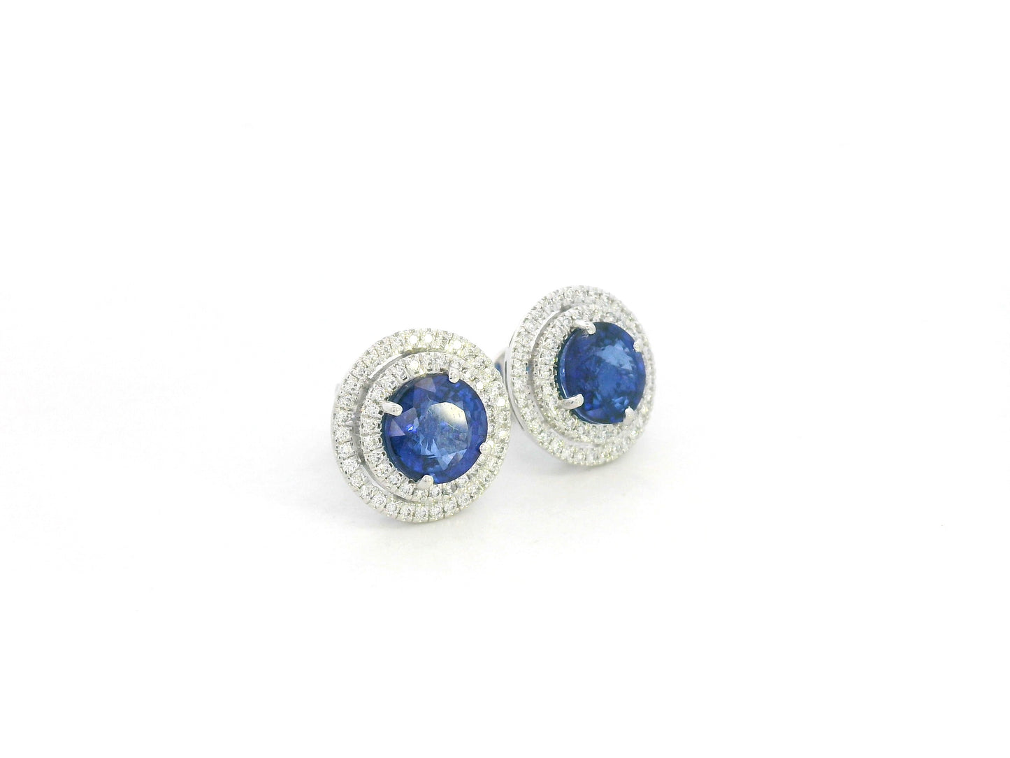 18K white gold blue sapphire halo stud earrings with diamond accents by Emirates Diamonds