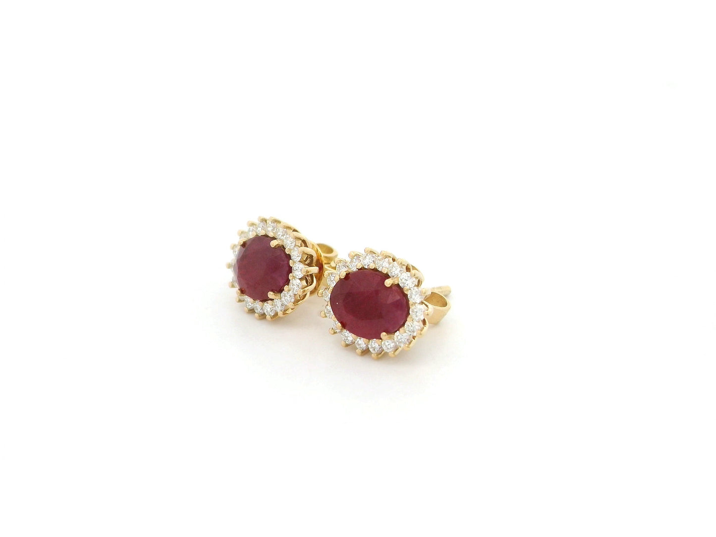 Ruby and diamond halo stud earrings in 18K yellow gold by Emirates Diamonds