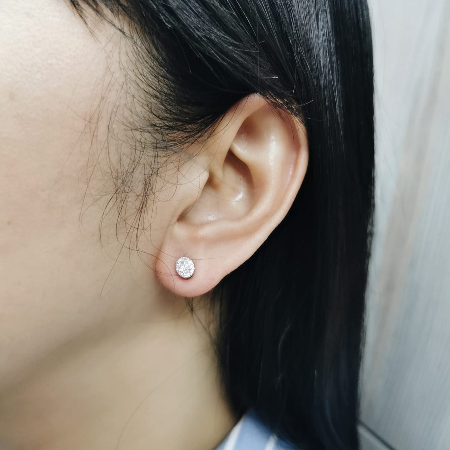 Oval diamond halo stud earrings in 18K white gold with 0.49 carats total diamond weight