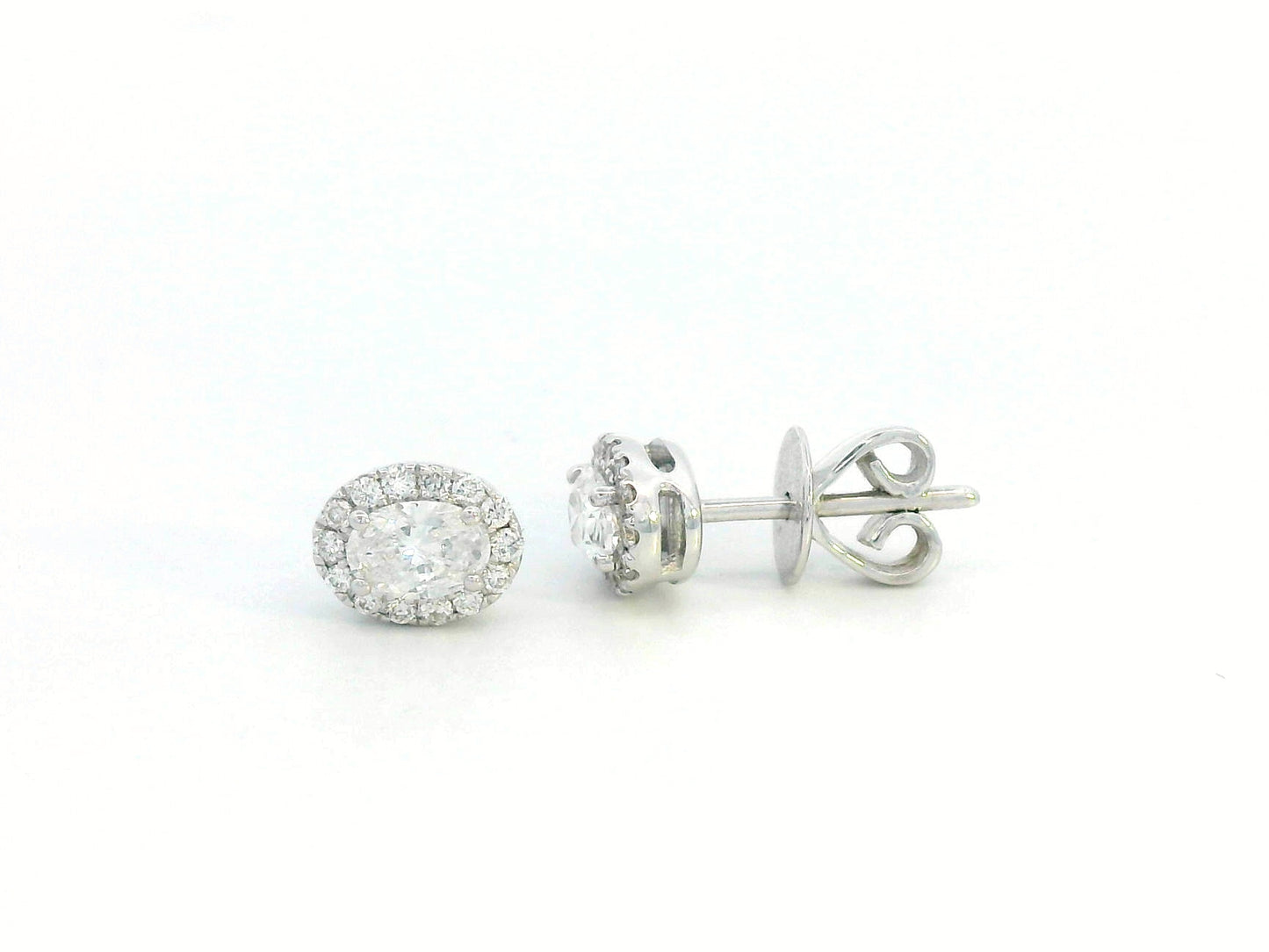 Oval diamond halo stud earrings in 18K white gold with 0.49 carats total diamond weight