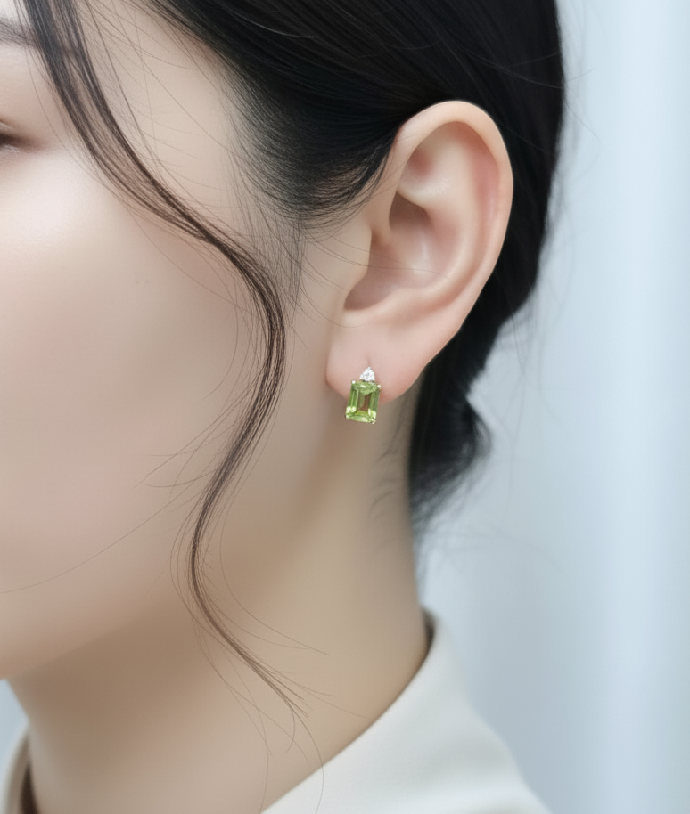 18K yellow gold peridot and diamond stud earrings – emerald-cut green peridot with diamond cluster accents by Emirates Diamonds.