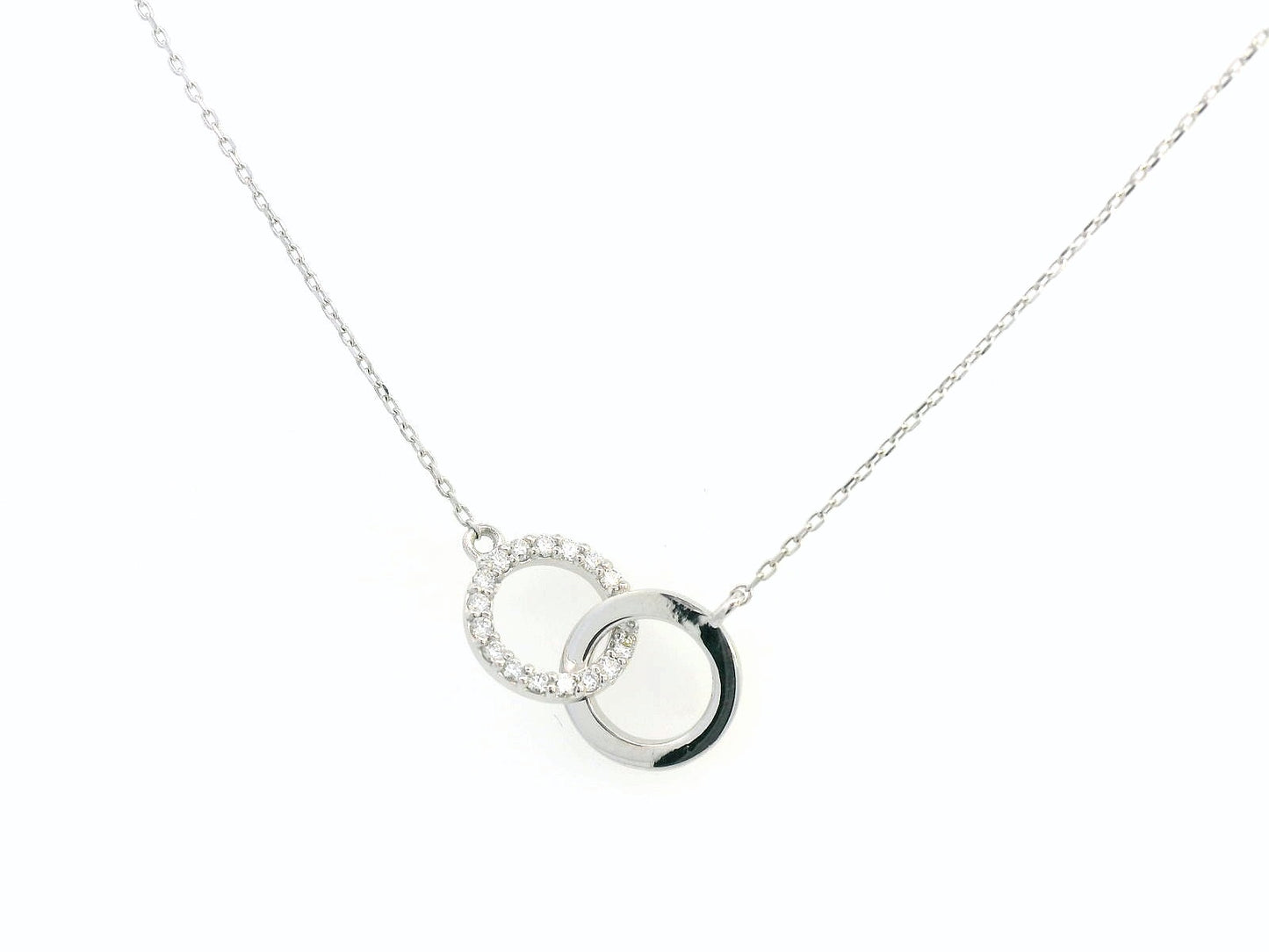 18K gold interlocking circles diamond pendant featuring 0.17 carat natural diamonds with a sleek polished gold circle. Chain not included; contact us for chain options.