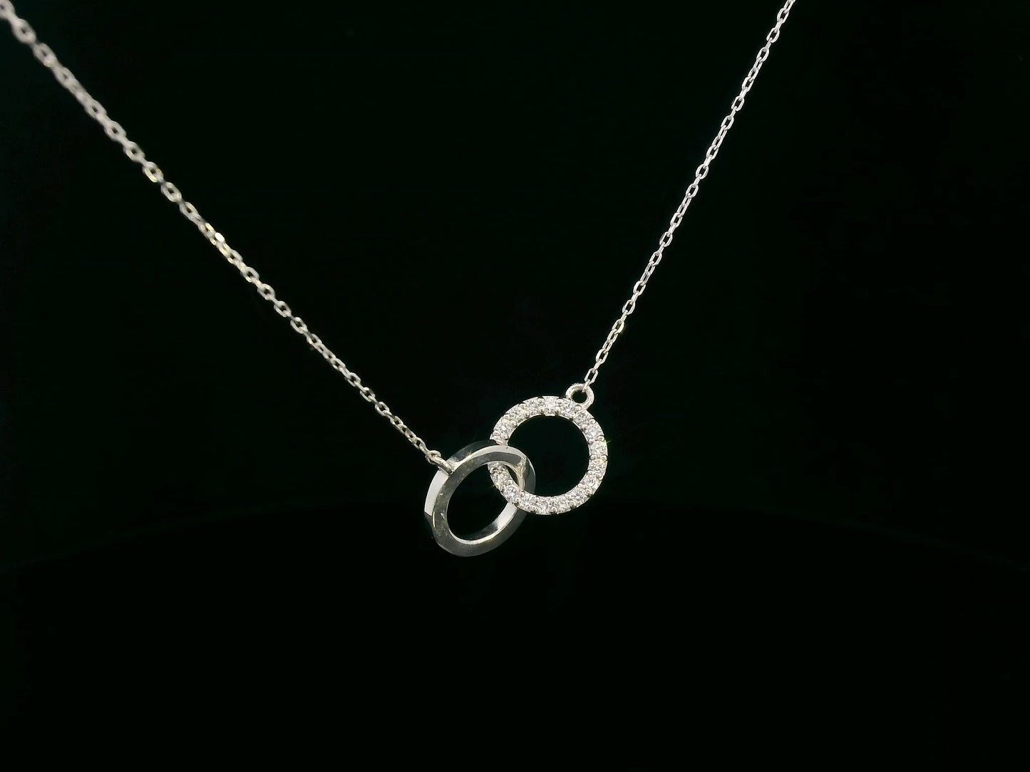 18K gold interlocking circles diamond pendant featuring 0.17 carat natural diamonds with a sleek polished gold circle. Chain not included; contact us for chain options.