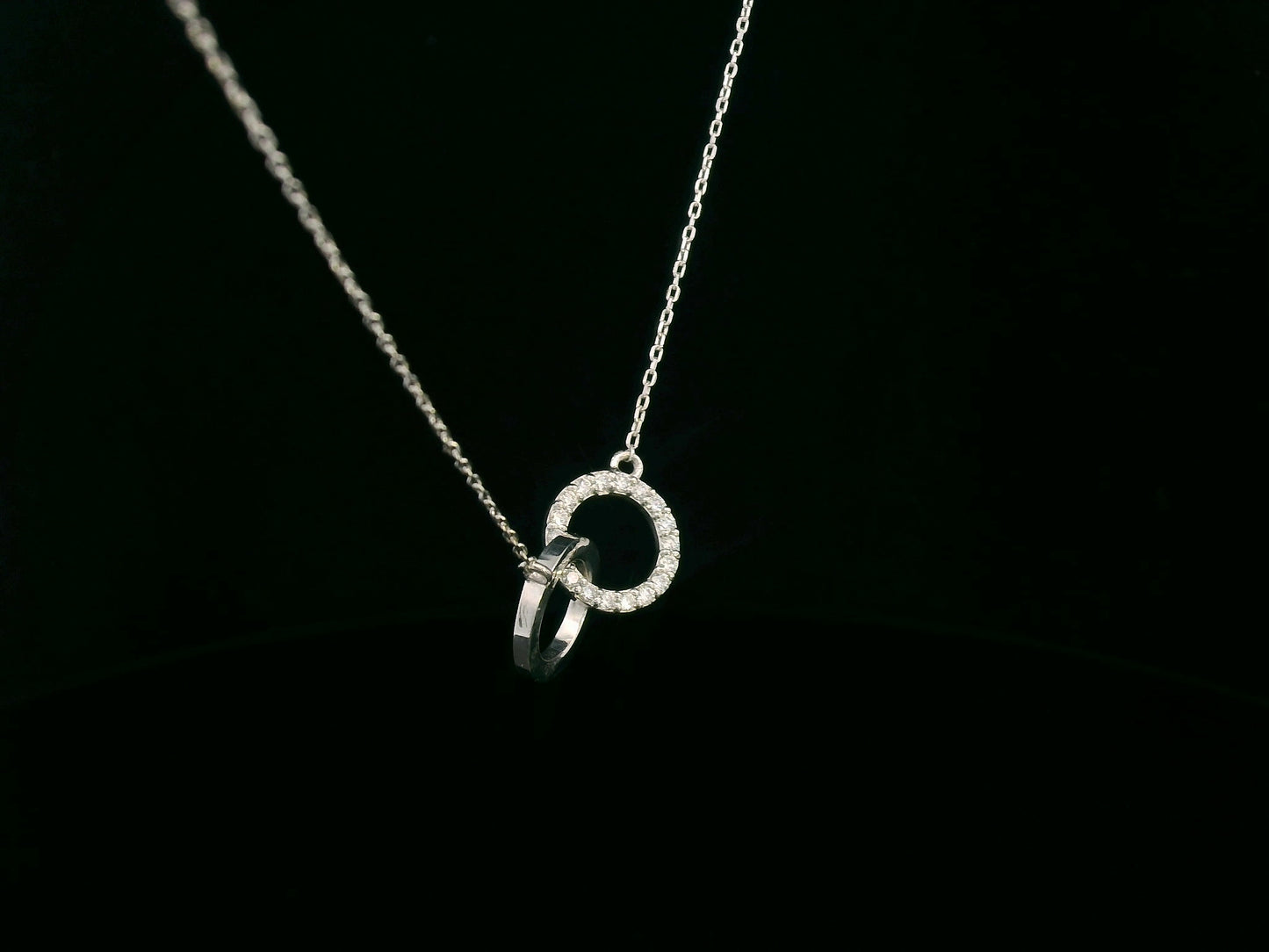 18K gold interlocking circles diamond pendant featuring 0.17 carat natural diamonds with a sleek polished gold circle. Chain not included; contact us for chain options.