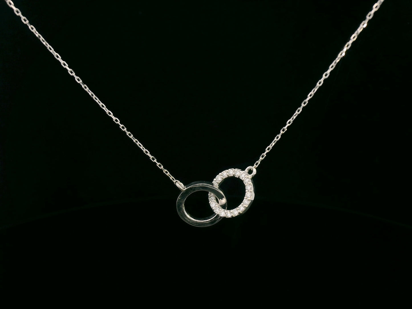 18K gold interlocking circles diamond pendant featuring 0.17 carat natural diamonds with a sleek polished gold circle. Chain not included; contact us for chain options.