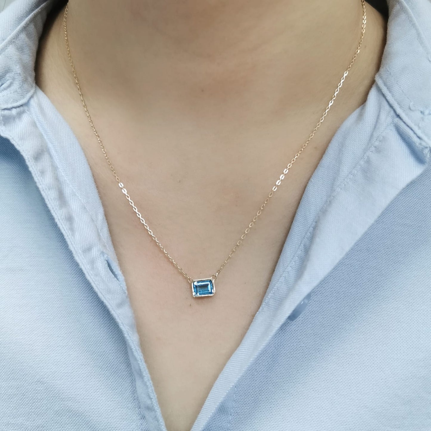 18K gold necklace with a bezel-set 1.17-carat emerald-cut London Blue Topaz, suspended from a fine gold chain for a minimalist, elegant look.