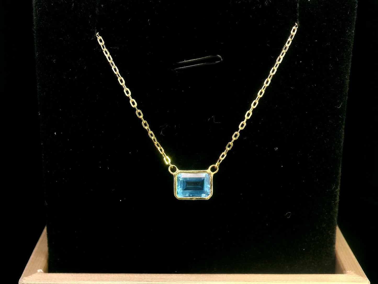 18K gold necklace with a bezel-set 1.17-carat emerald-cut London Blue Topaz, suspended from a fine gold chain for a minimalist, elegant look.