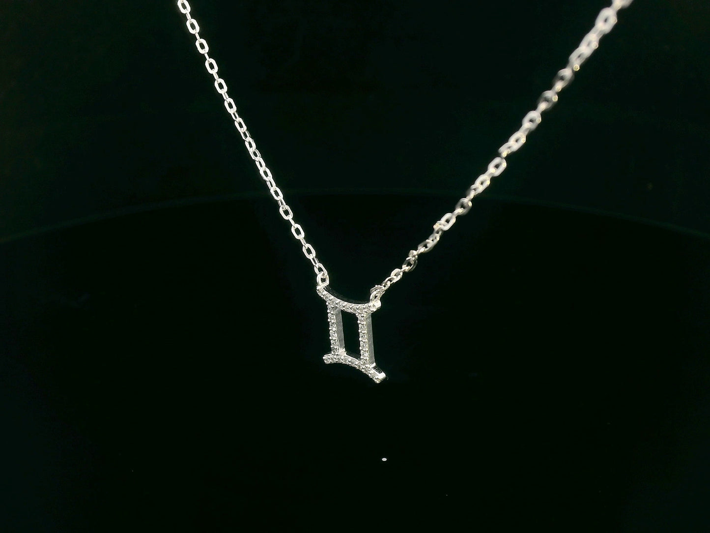 Gemini zodiac necklace in 18K white gold set with 0.10 carat round diamonds on fine chain